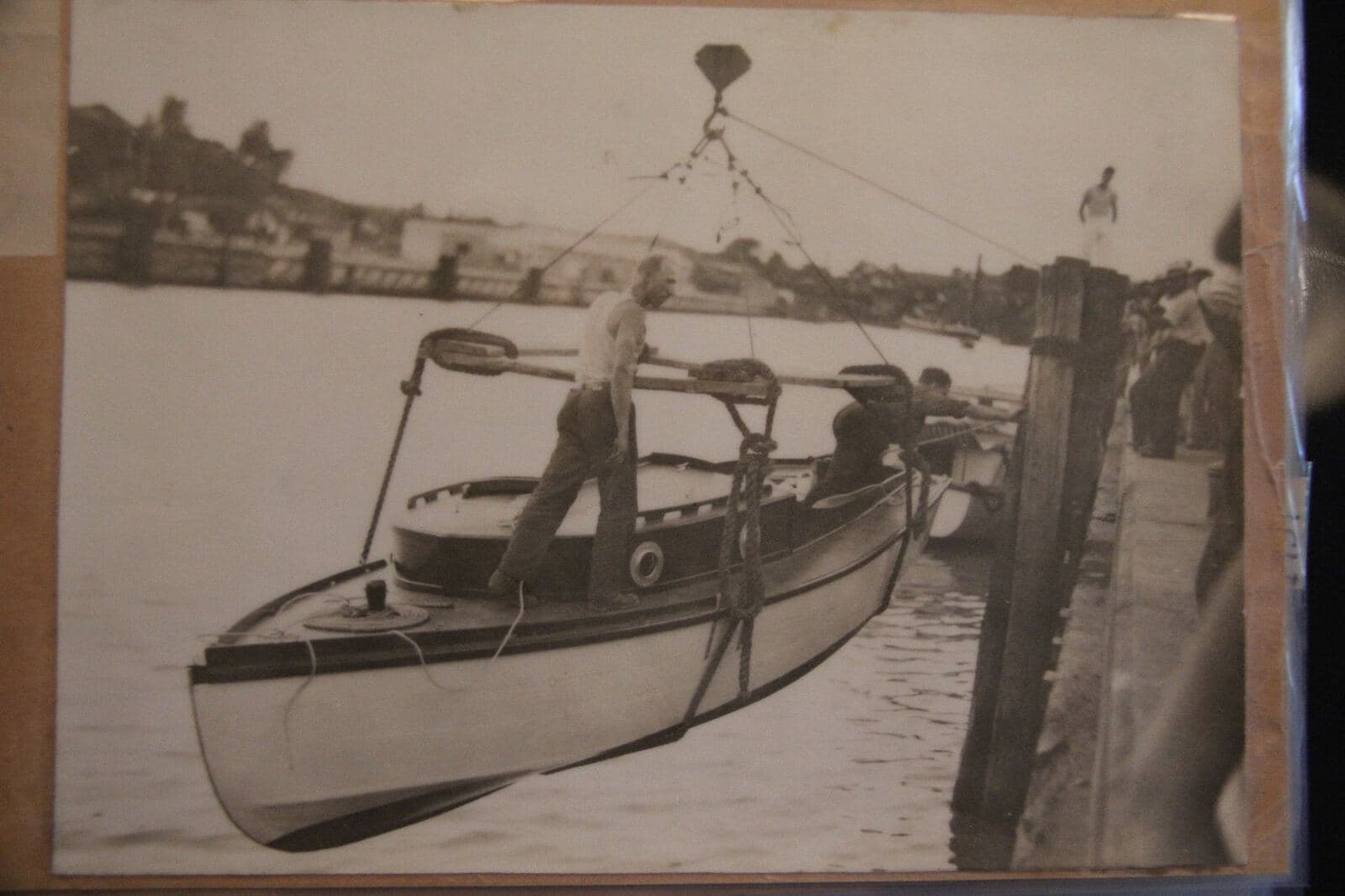 An archival photograph of an early club boat tied up on the creek