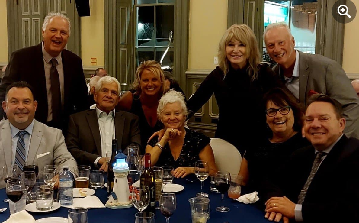 A table of guests smiling for the camera
