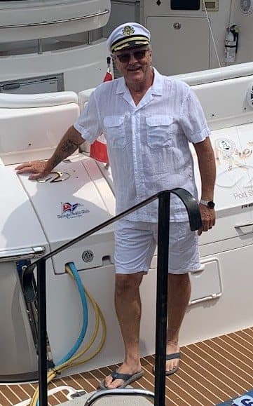 Commodore Rick Banman in his whites aboard his boat