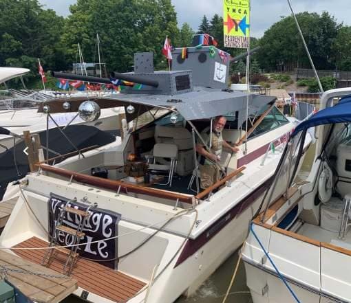 A cruiser decorated for the parade at its dock