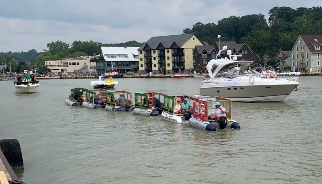 The Port Stanley rail road train of dinghies with a cruiser behind