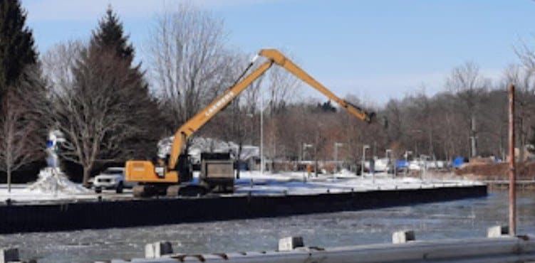 The long-reach excavator working from the bank of Kettle Creek