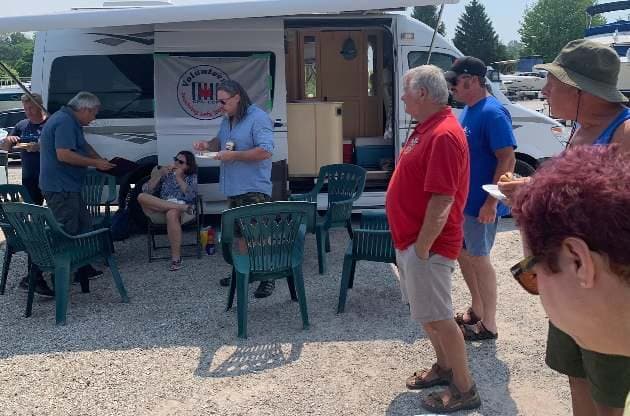 Members and squadron volunteers gathered at the picnic tables