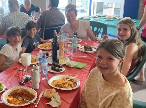 A family table with plates of spaghetti