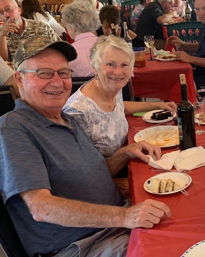 Members raising a glass at their table