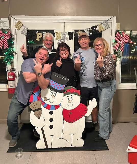 Members posing with a snowman cut-out