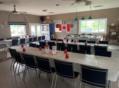 The clubhouse tables set in white for the barbecue