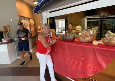 Members in red and white by the buffet