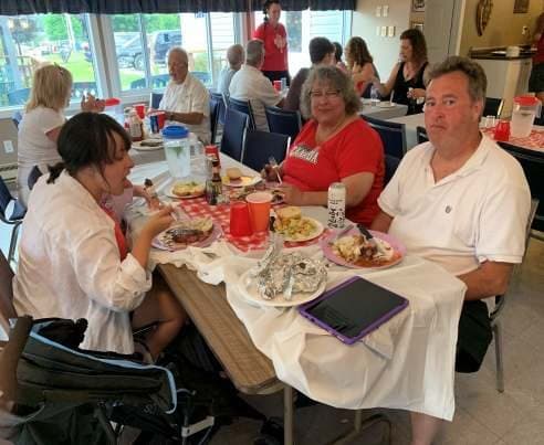 Members sharing a table by the windows
