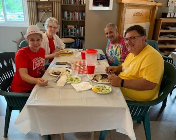 Members in Canada Day shirts at their table