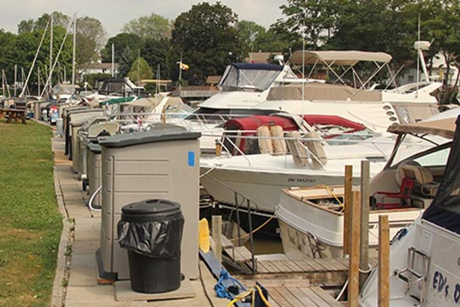 Cruisers tied up along the club docks, each with its own dock box