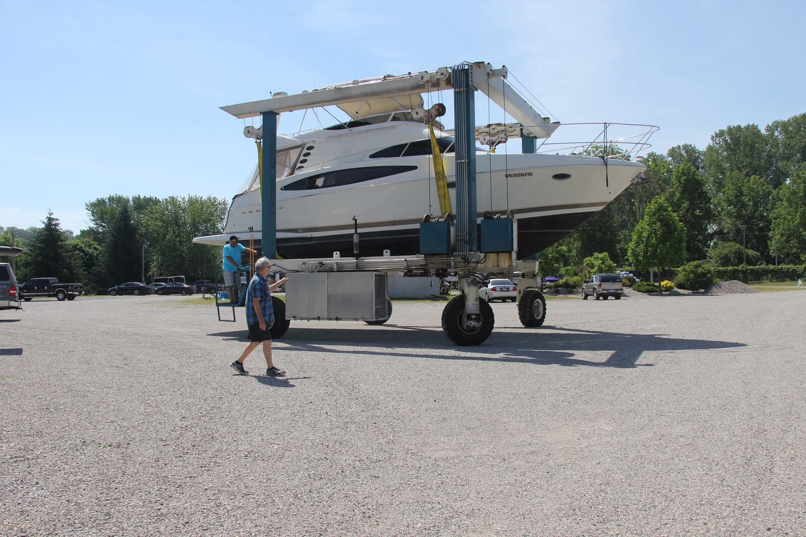 Members moving a cruiser across the yard in the club travel lift